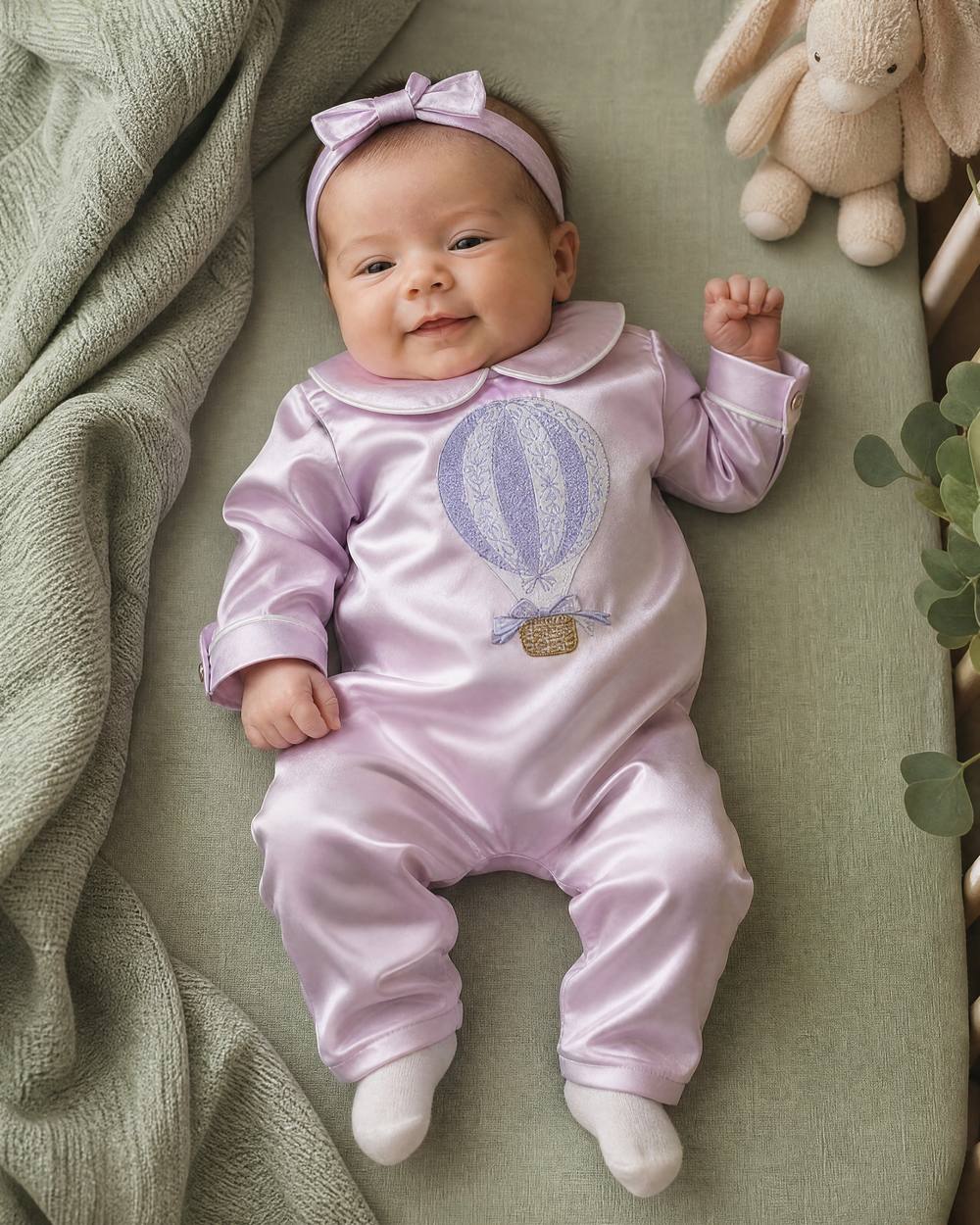 Baby girl in a personalised lilac silk Zyra Baby romper