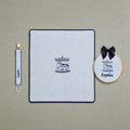 Just the Essentials ice blue gift bundle laid out flat — personalised ice blue silk wrapping sheet, name frame and pacifier holder
