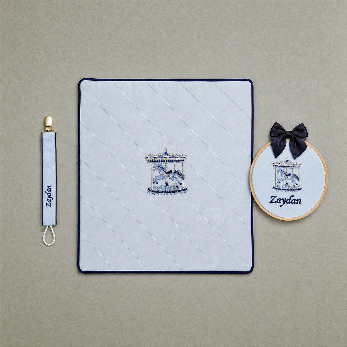 Just the Essentials ice blue gift bundle laid out flat — personalised ice blue silk wrapping sheet, name frame and pacifier holder