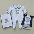 Welcome to the World ice blue gift bundle laid out flat — personalised ice blue silk romper, wrapping sheet, name flag and pacifier holder