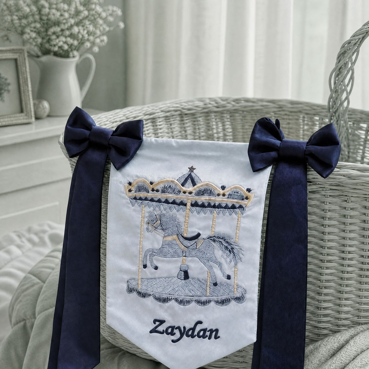 Personalised ice blue silk name flag hanging on a nursery wall