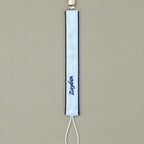 Ice blue silk pacifier holder styled in a nursery setting