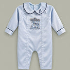 Ice blue silk baby romper with navy piping, an embroidered initial on the Peter Pan collar and a carousel motif with gold canopy at the chest