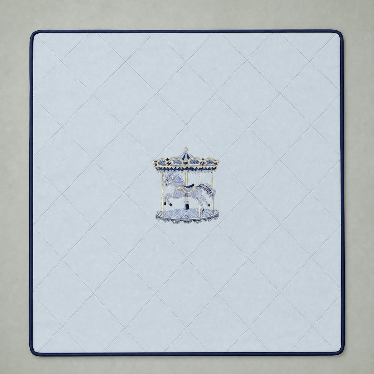 Ice blue silk baby wrapping sheet with navy trim, an embroidered carousel and a name in navy script