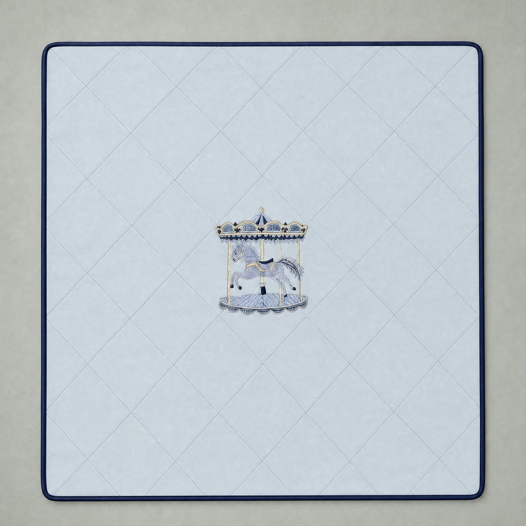 Ice blue silk baby wrapping sheet with navy trim, an embroidered carousel and a name in navy script