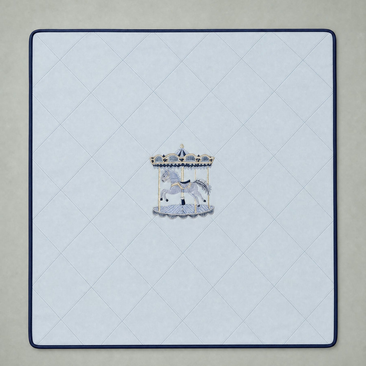 Ice blue silk baby wrapping sheet with navy trim, an embroidered carousel and a name in navy script