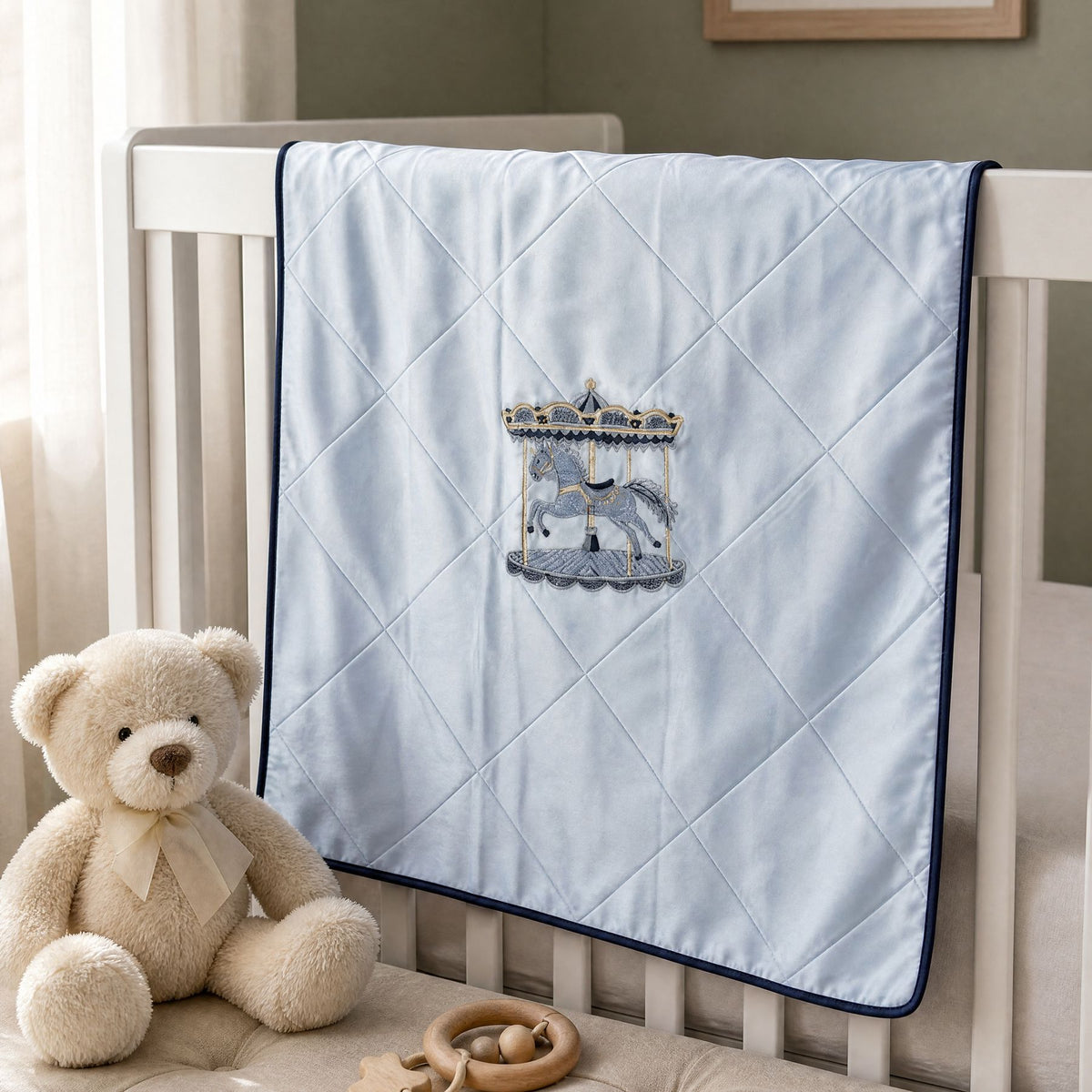 Ice blue silk wrapping sheet with navy detailing, styled in a nursery setting