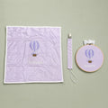 Just the Essentials lilac gift bundle laid out flat — personalised lilac silk wrapping sheet, name frame and pacifier holder
