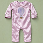 Lilac silk baby romper with ivory piping, a Peter Pan collar and an embroidered hot air balloon with a gold basket at the chest