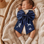 Navy silk announcement bow styled for a birth announcement photograph