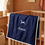 Navy silk baby wrapping sheet styled in a nursery setting