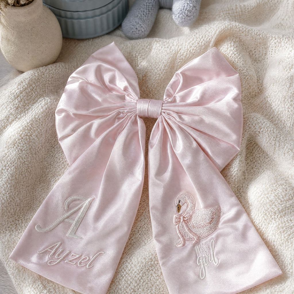Personalised pink silk announcement bow styled for a new baby girl announcement