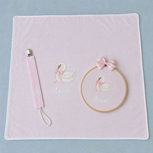Just the Essentials pink gift bundle laid out flat — personalised pink silk wrapping sheet, name frame and pacifier holder