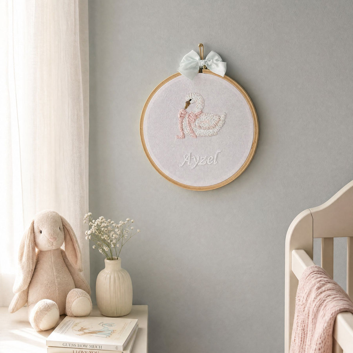 Personalised pink name frame styled on a nursery wall