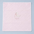 Quilted pink silk baby wrapping sheet with white binding, an embroidered swan and a name in soft pink script