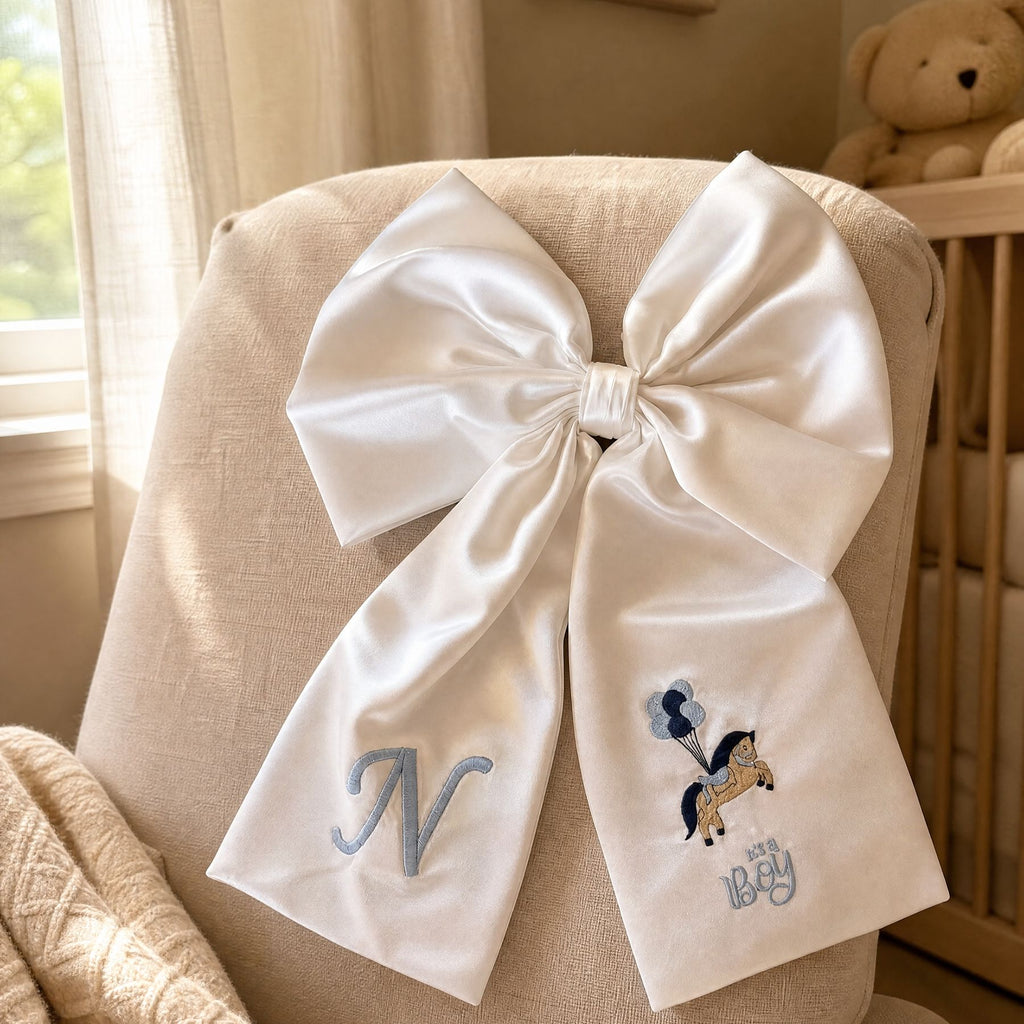 Ivory silk announcement bow styled for a birth announcement photograph