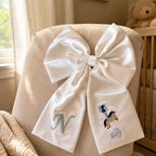 Ivory silk announcement bow styled for a birth announcement photograph
