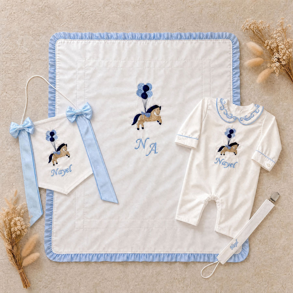 Welcome to the World white and blue gift bundle shown spread out, all four personalised ivory silk pieces
