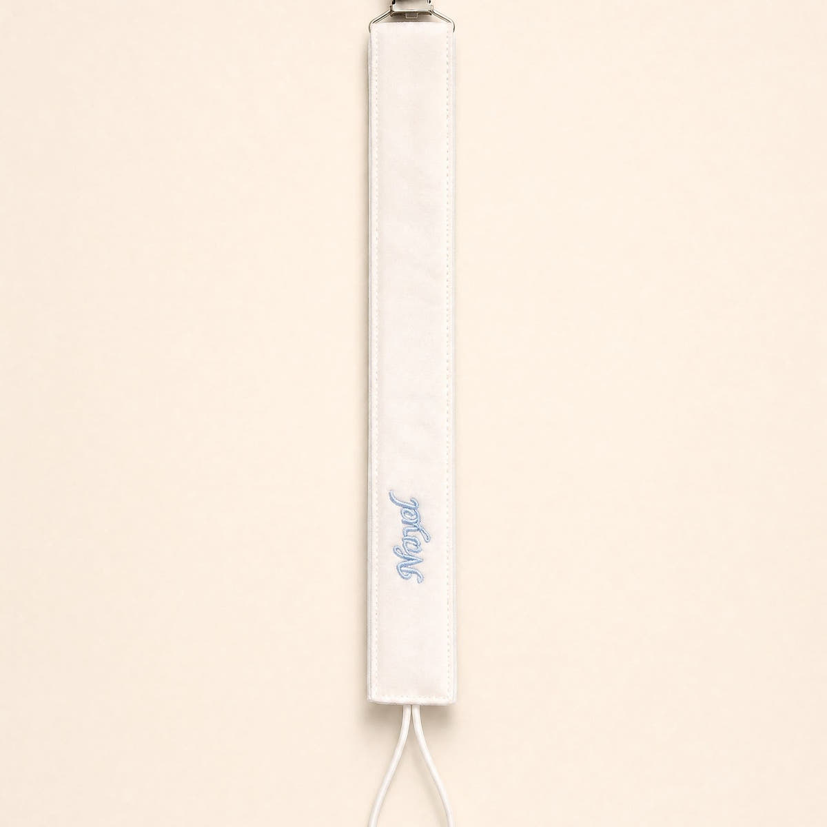 Ivory silk pacifier holder with pale blue detailing and a baby's name embroidered in pale blue script