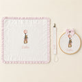 Just the Essentials white and pink gift bundle laid out flat — personalised ivory silk wrapping sheet, name frame and pacifier holder