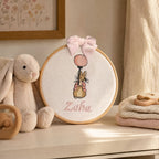 Personalised white and pink name frame styled on a nursery wall