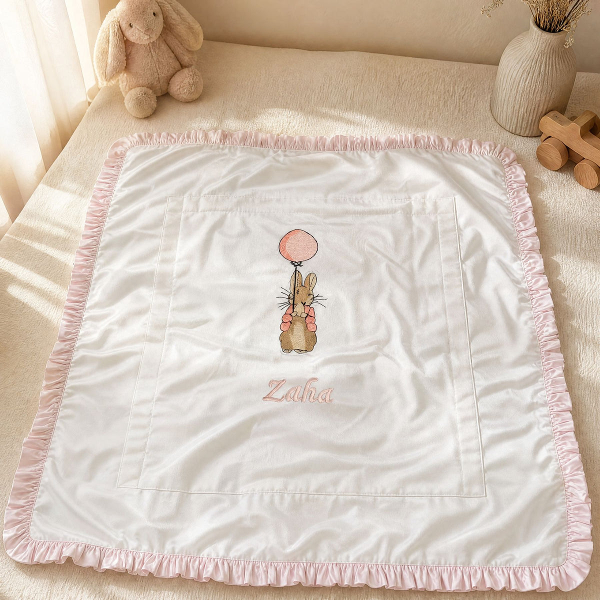 White and pink quilted silk wrapping sheet styled in a nursery setting